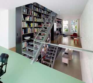 Illustration for article titled This Dream House Was Entirely Built Around a Giant Three-Story-High Bookshelf
